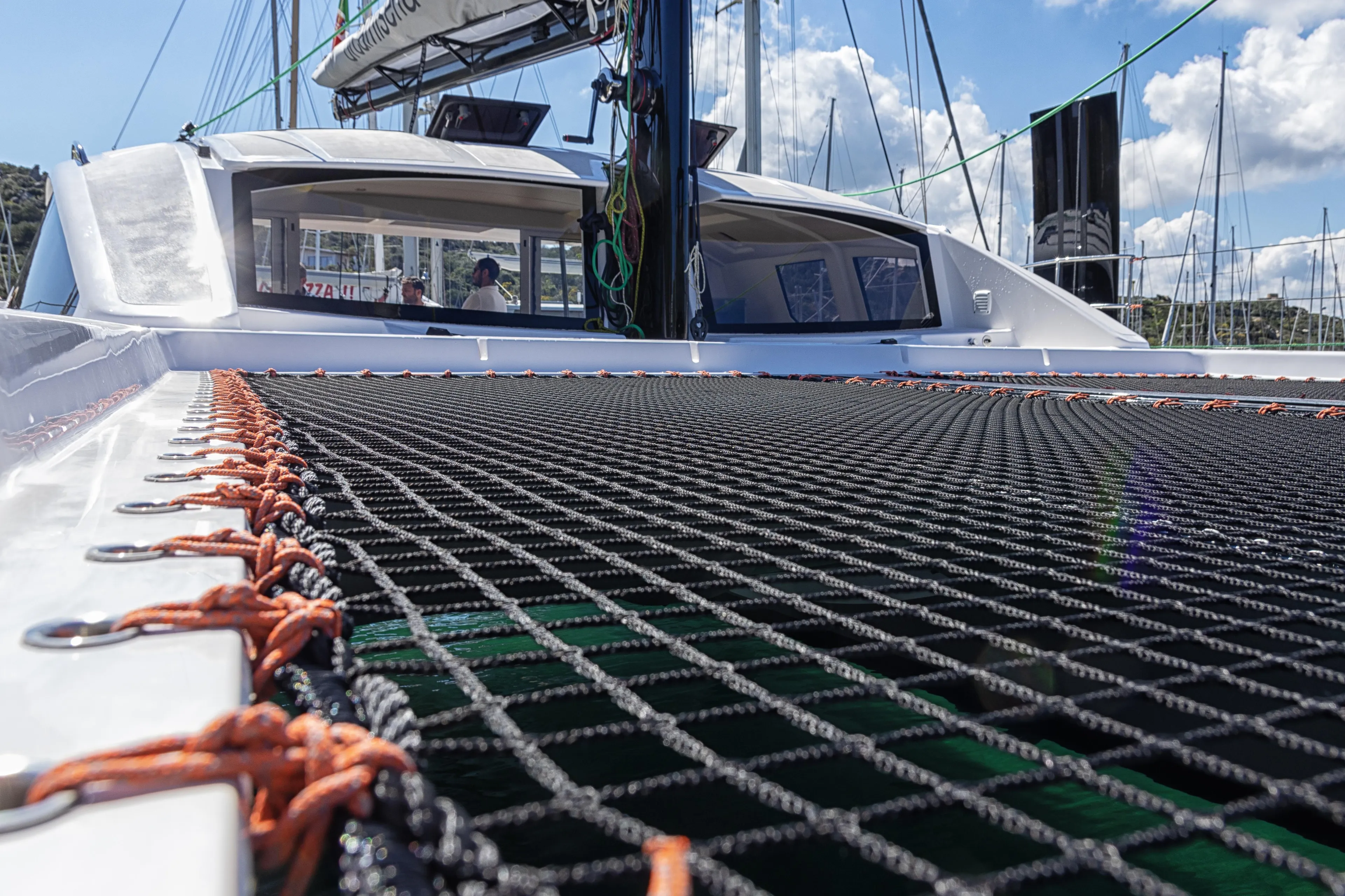 2025 Comar C-Cat 48 catamaran with netting and cabin view under a sunny sky.