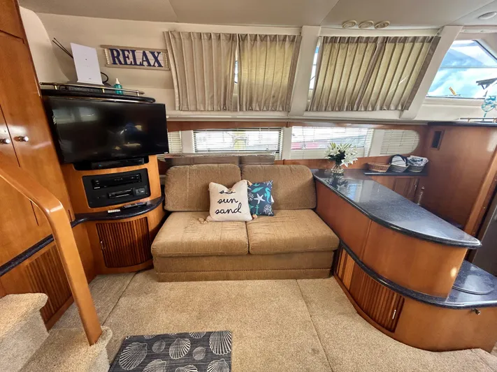 Carolina Breeze Yacht Photos Pics Interior of 2002 Carver 444 Cockpit Motor Yacht with cozy seating area and entertainment center.