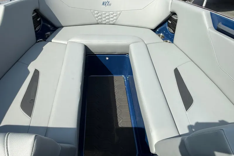  Yacht Photos Pics Interior seating of 2026 MasterCraft NXT24 boat, featuring sleek gray upholstery.