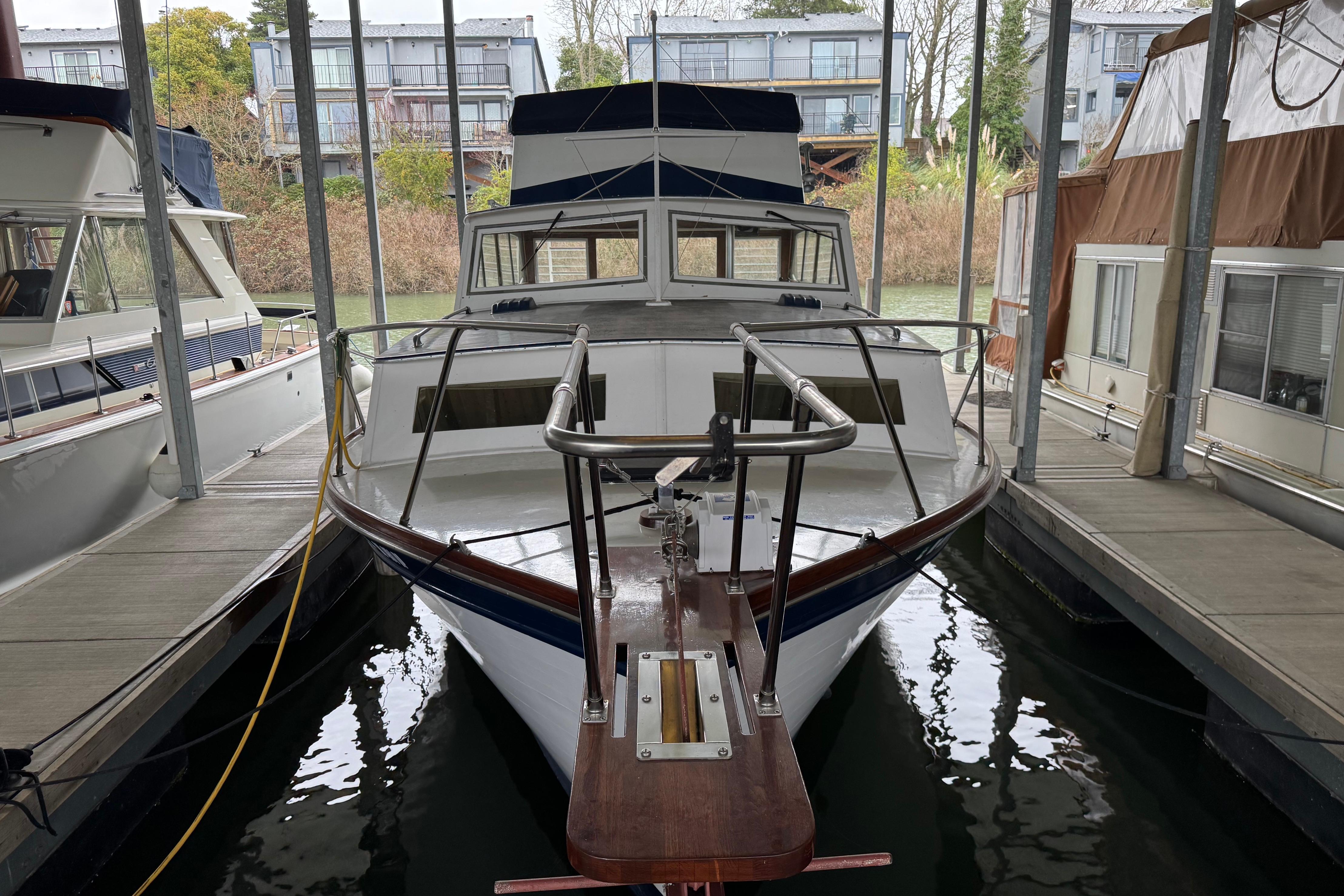 1967 Pacemaker 37 boat docked in a marina, surrounded by other vessels.