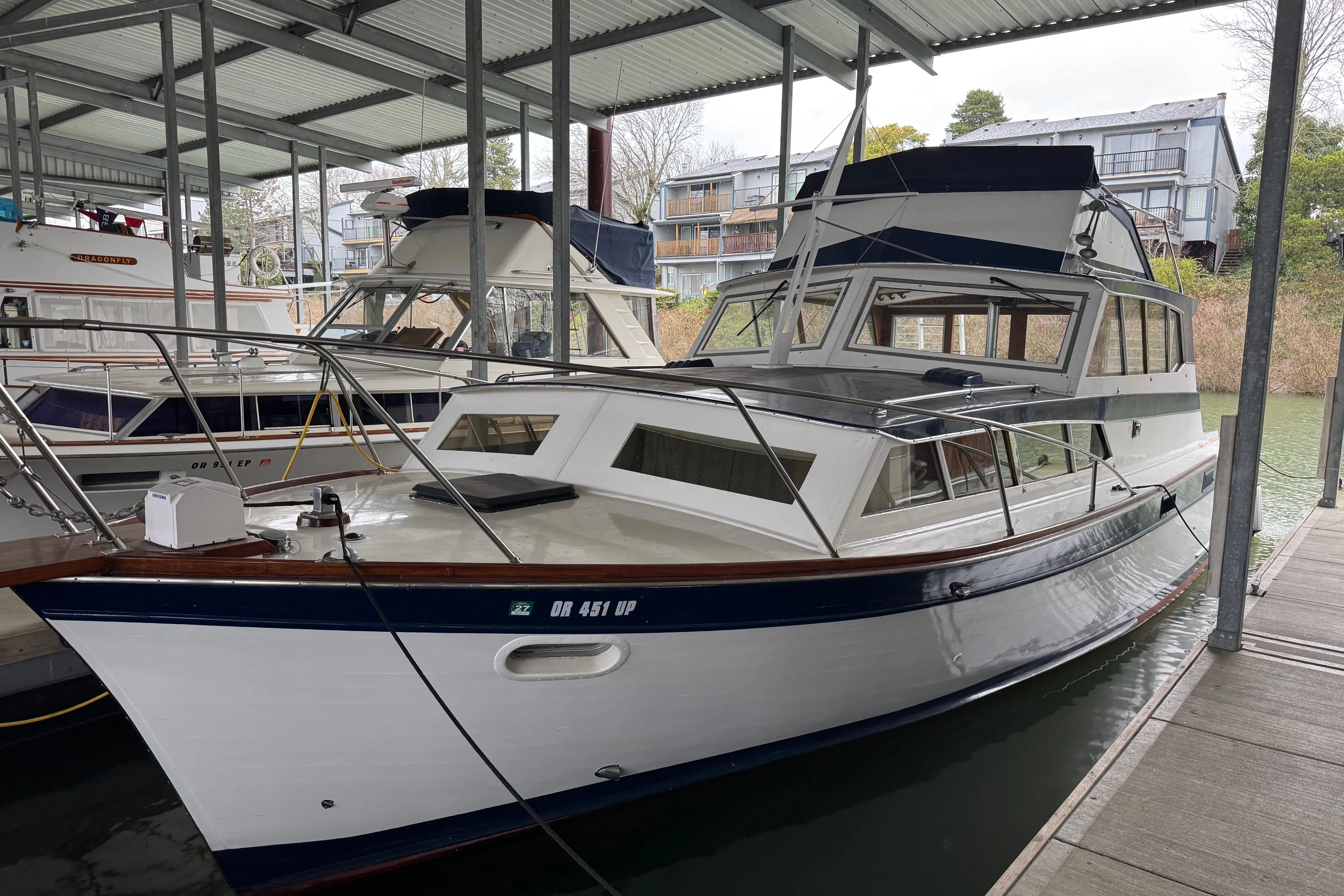 1967 Pacemaker 37 boat docked in a covered marina.
