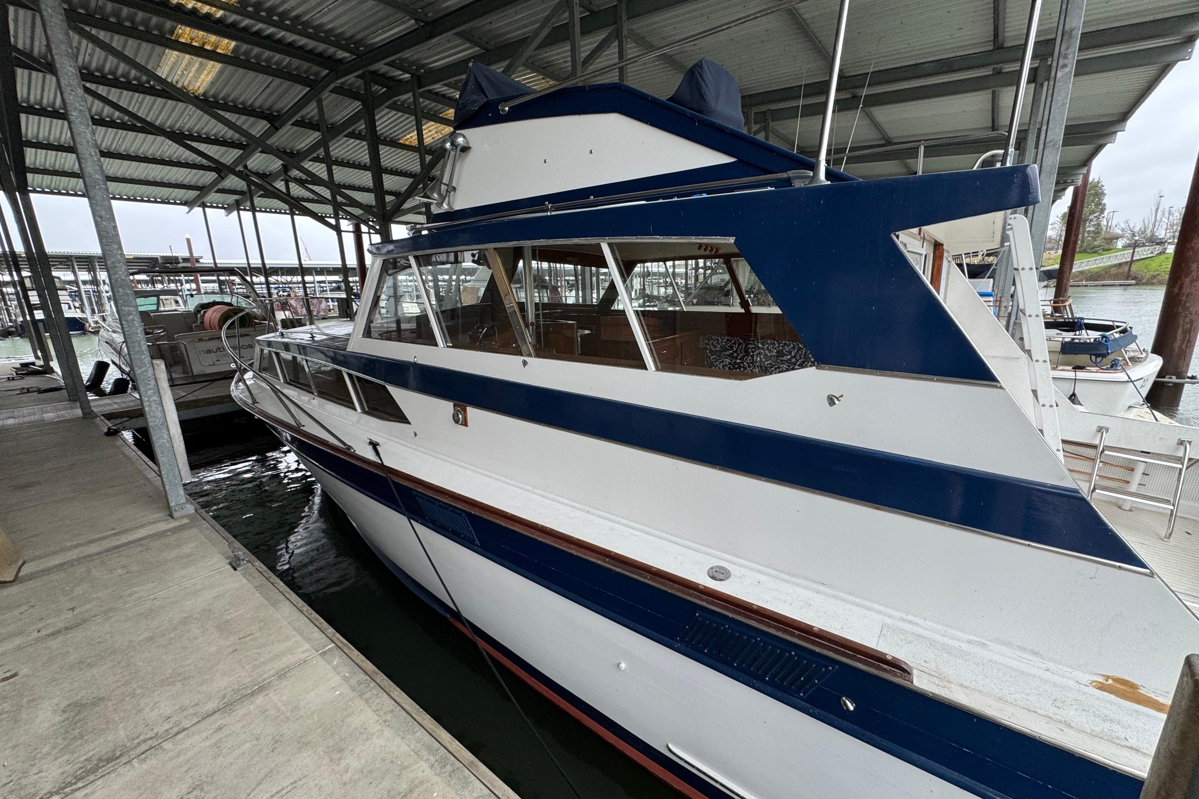 1967 Pacemaker 37 boat docked in a covered marina.