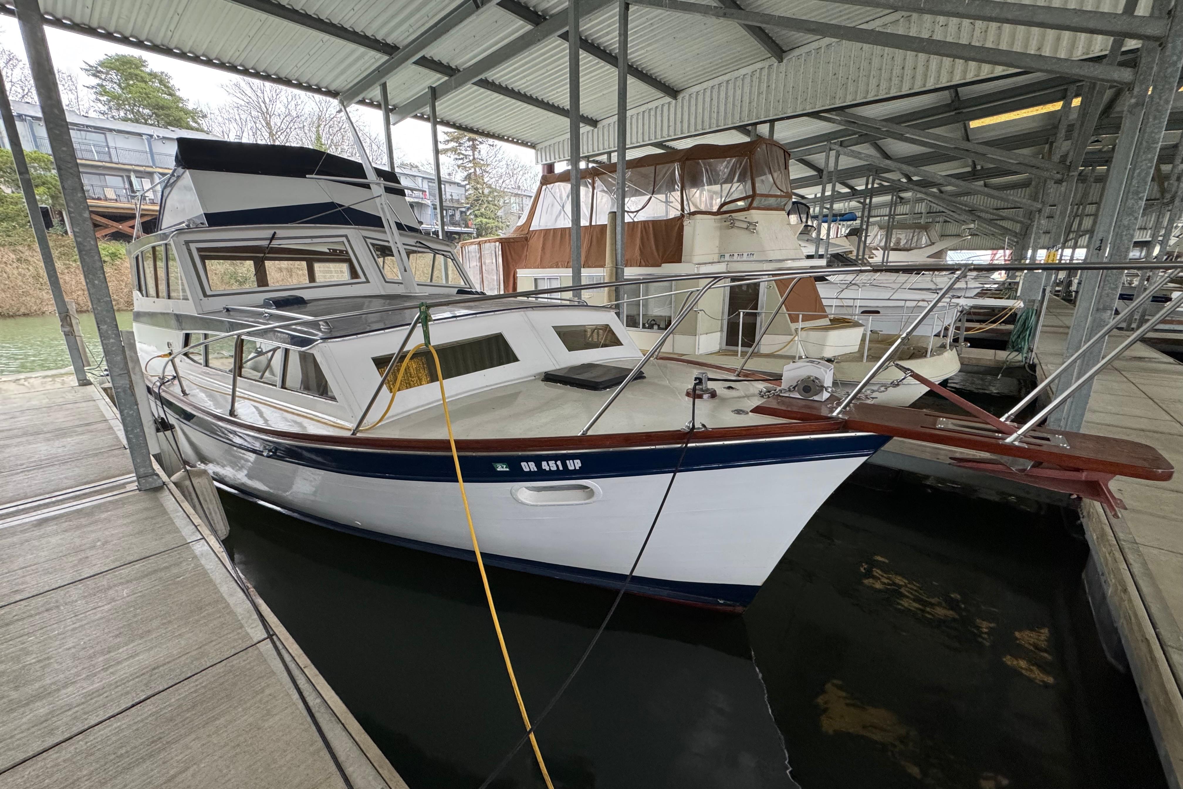 1967 Pacemaker 37 boat docked in a covered marina, showcasing classic design.