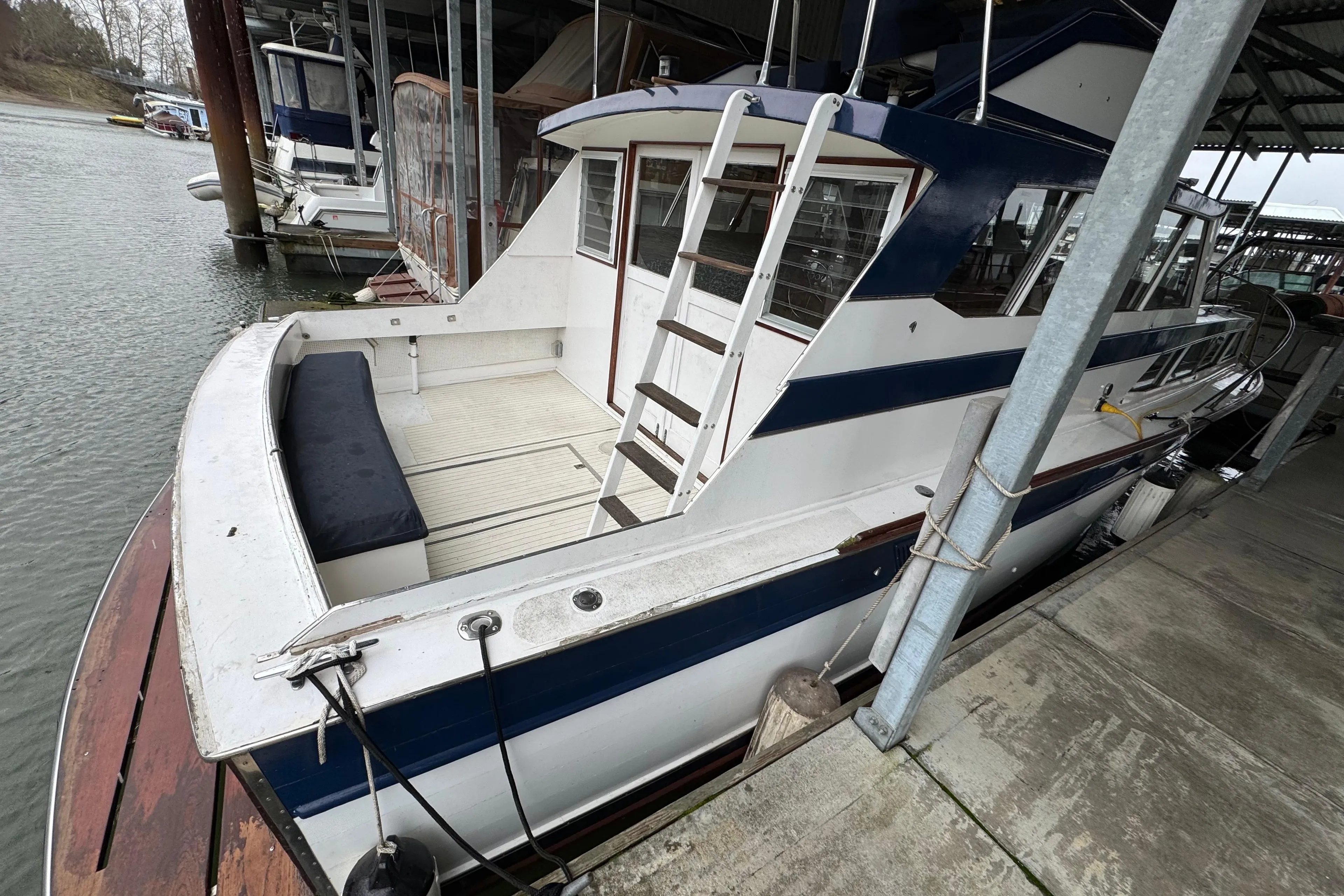1967 Pacemaker 37 boat docked in marina, featuring blue and white exterior.