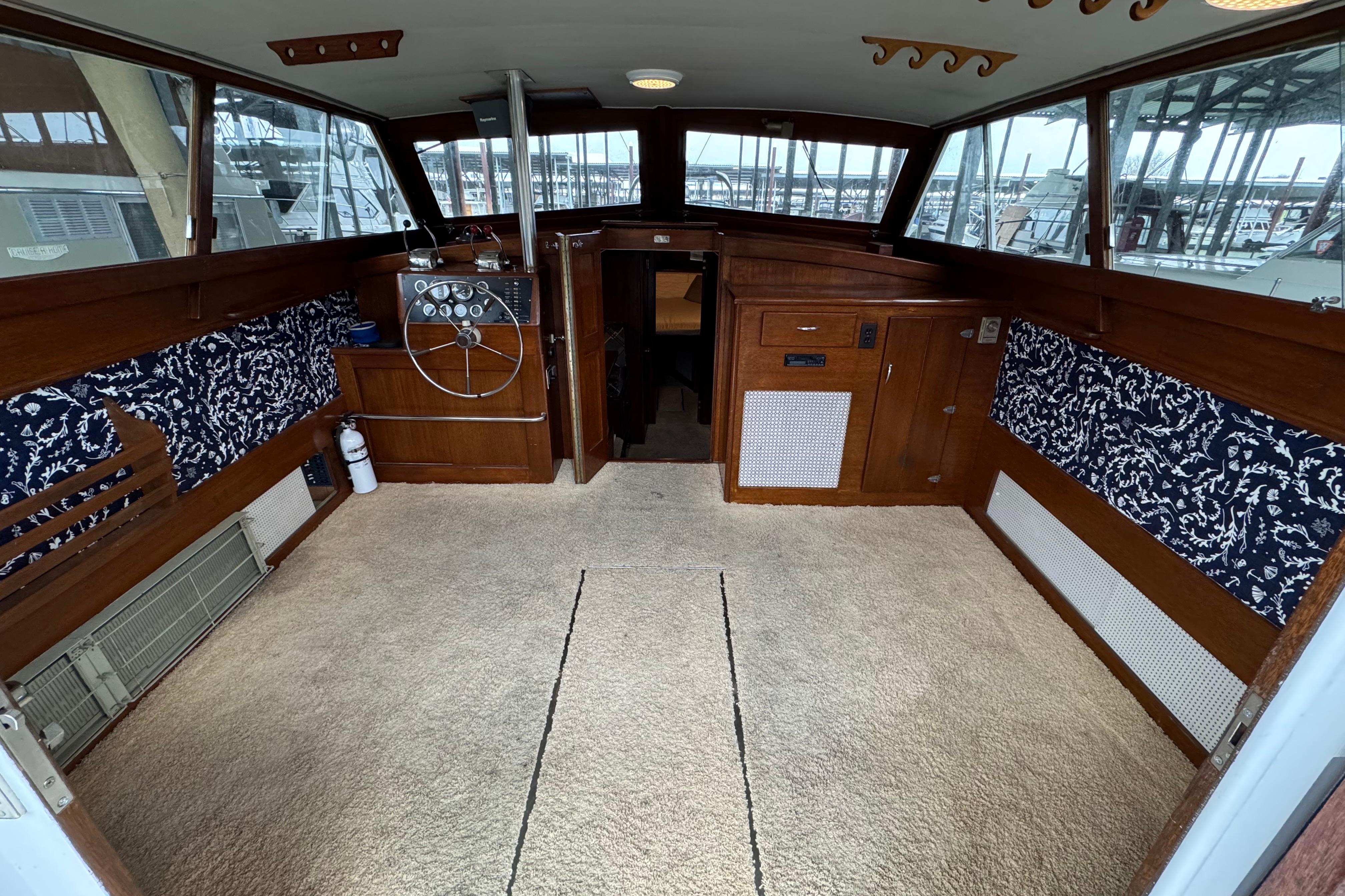 Interior of a 1967 Pacemaker 37 boat with wood paneling and nautical decor.