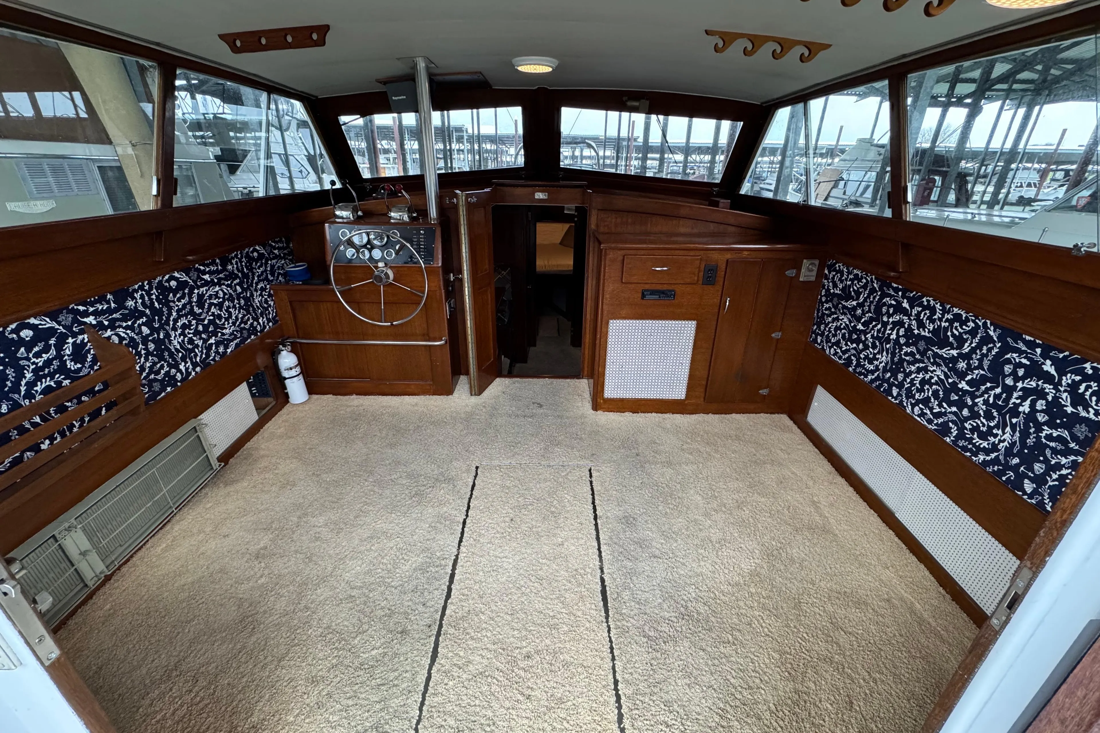 Interior of a 1967 Pacemaker 37 boat with wood paneling and nautical decor.