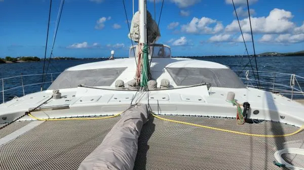 Fat Cat Yacht Photos Pics Sailing catamaran on water, Custom Morelli-Miller 1991, clear sky, calm sea.