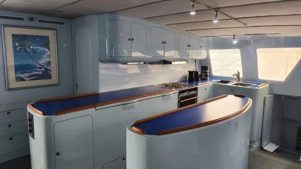 Fat Cat Yacht Photos Pics Spacious 1991 Custom Morelli-Miller yacht kitchen with modern design and blue countertops.