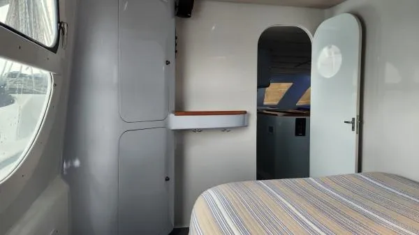 Fat Cat Yacht Photos Pics Interior of 1991 Custom Morelli-Miller boat with bed, cabinets, and open door.