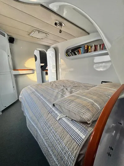Fat Cat Yacht Photos Pics Interior of a 1991 Custom Morelli-Miller with bed, bookshelves, and modern design.