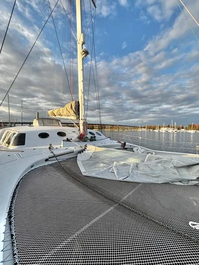 Fat Cat Yacht Photos Pics Sailboat on calm water, Custom Morelli-Miller 1991, under a partly cloudy sky.