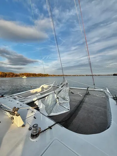 Fat Cat Yacht Photos Pics Sailboat deck view on calm water, Custom Morelli-Miller 1991, under a partly cloudy sky.