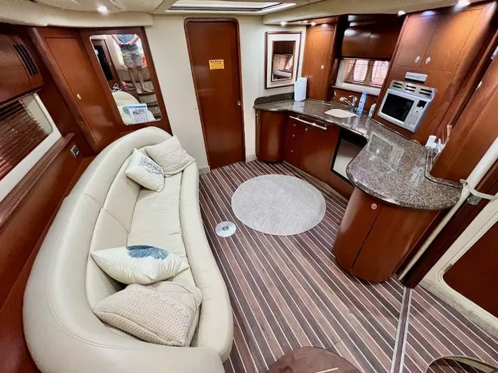 Yacht Photos Pics Luxurious interior of 2007 Sea Ray 44 Sundancer yacht with modern kitchen and cozy seating.