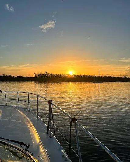  Yacht Photos Pics 2007 Sea Ray 44 Sundancer at sunset on calm waters.