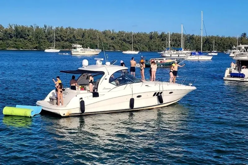  Yacht Photos Pics 2007 Sea Ray 44 Sundancer yacht with people enjoying a sunny day on the water.