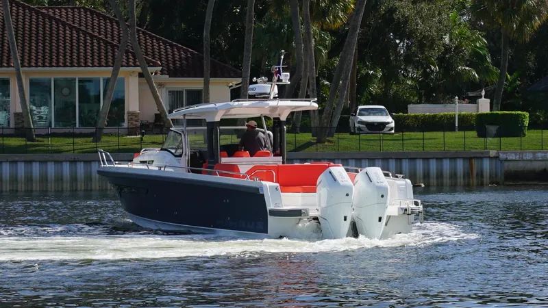 In-stock 2024 Nimbus T11 #260 Yacht Photos Pics 2024 Nimbus Tender 11 #260 cruising on a scenic waterfront with lush greenery.