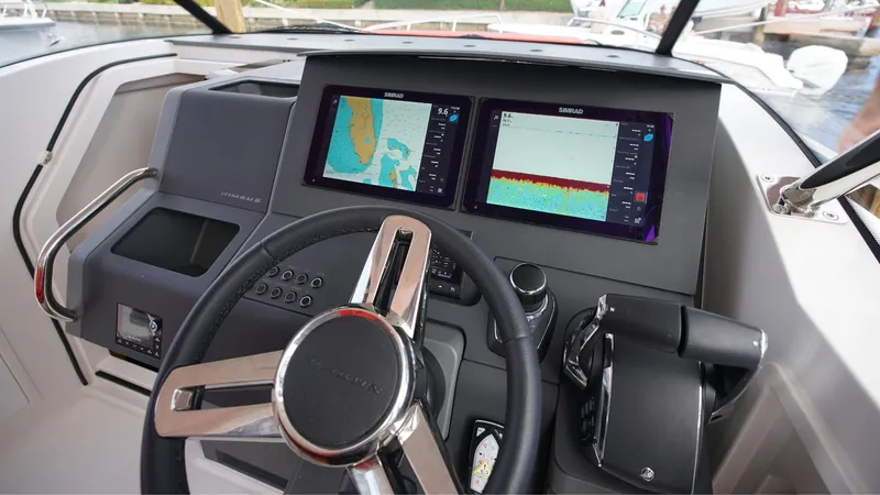 In-stock 2024 Nimbus T11 #260 Yacht Photos Pics 2024 Nimbus Tender 11 #260 helm with dual navigation screens and modern controls.