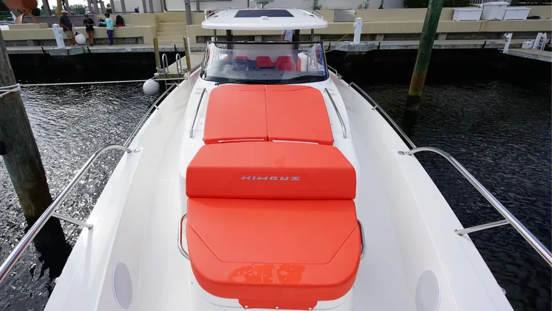 In-stock 2024 Nimbus T11 #260 Yacht Photos Pics 2024 Nimbus Tender 11 #260 with orange sunbed, docked at marina.