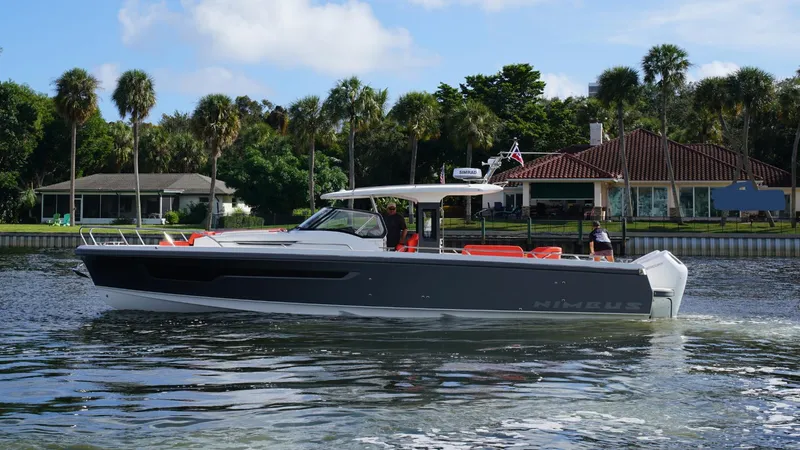In-stock 2024 Nimbus T11 #260 Yacht Photos Pics 2024 Nimbus Tender 11 #260 cruising on a scenic waterway with lush greenery.
