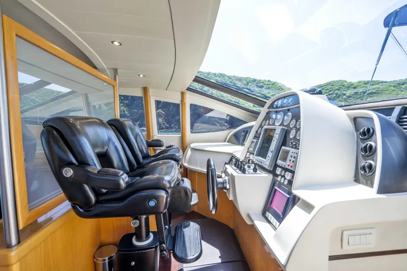 Denise Yacht Photos Pics Helm station of 2005 Pershing 76 Motor Yacht with leather seats and advanced navigation controls.