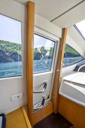 Denise Yacht Photos Pics Interior view of 2005 Pershing 76 Motor Yacht with scenic ocean backdrop.