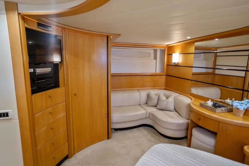 Denise Yacht Photos Pics Luxurious interior of a 2005 Pershing 76 Motor Yacht with wooden cabinetry and plush seating.