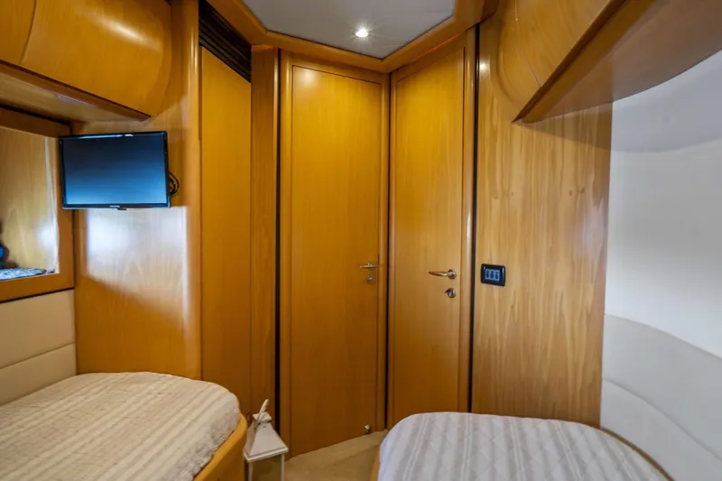 Denise Yacht Photos Pics Interior cabin of 2005 Pershing 76 Motor Yacht with twin beds and TV.