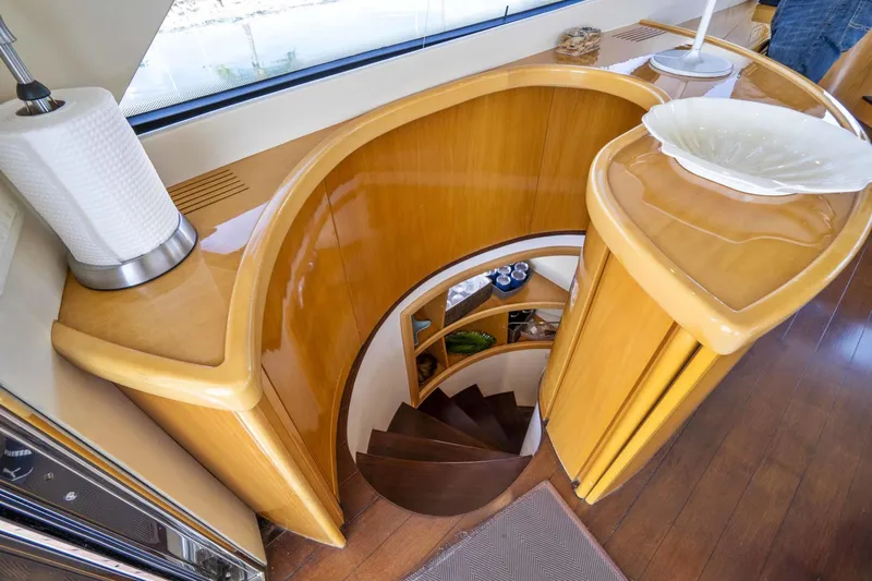 Denise Yacht Photos Pics Interior of 2005 Pershing 76 Motor Yacht with curved wooden staircase.