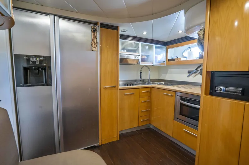Denise Yacht Photos Pics Modern kitchen in a 2005 Pershing 76 Motor Yacht with stainless steel appliances.
