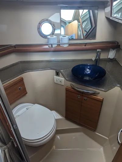 Yacht Photos Pics 2017 Ranger Tugs R-298 bathroom with modern sink, toilet, and porthole window.