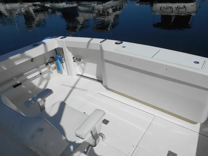 Mistress Yacht Photos Pics 1998 Cabo 31 Express boat deck with seating, docked at marina.