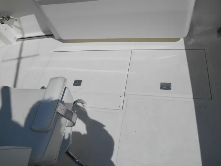 Mistress Yacht Photos Pics 1998 Cabo 31 Express boat deck with white seating and storage compartments.