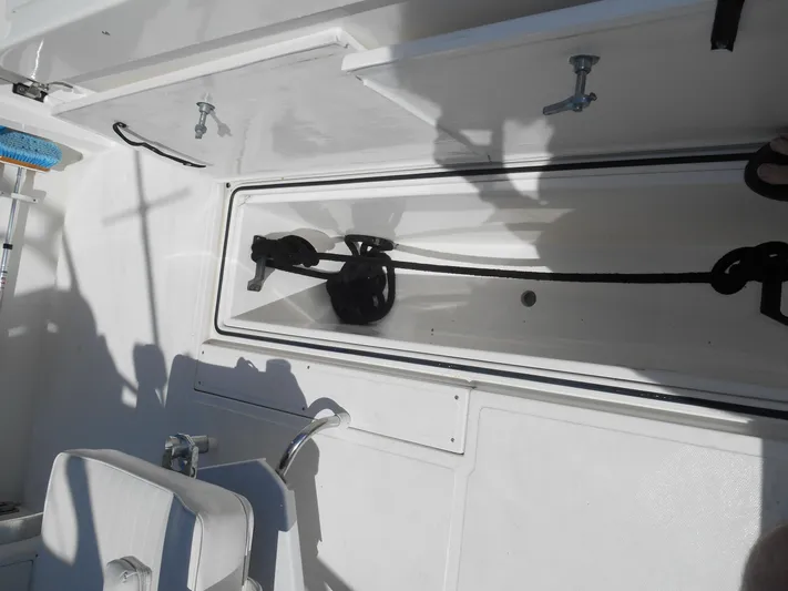 Mistress Yacht Photos Pics 1998 Cabo 31 Express boat interior with storage compartment and seating.