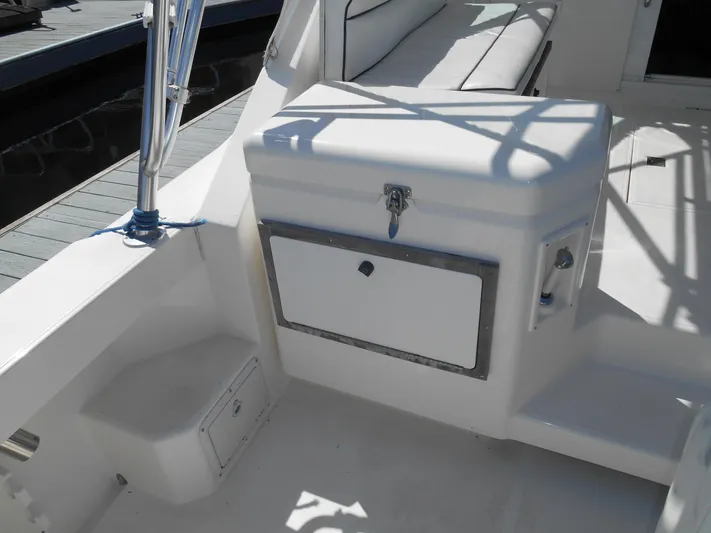 Mistress Yacht Photos Pics 1998 Cabo 31 Express boat interior with seating and storage compartment.