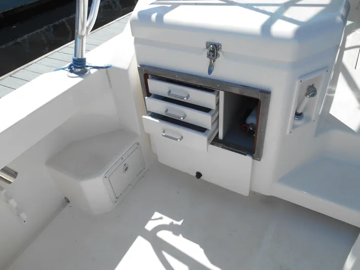 Mistress Yacht Photos Pics 1998 Cabo 31 Express boat interior with storage drawers and compartments.