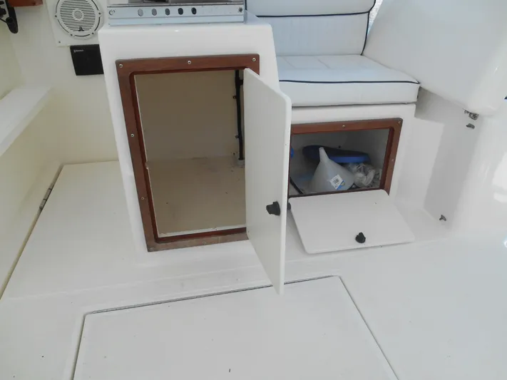 Mistress Yacht Photos Pics 1998 Cabo 31 Express boat interior with open storage compartments.