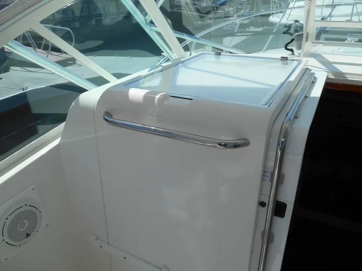 Mistress Yacht Photos Pics 1998 Cabo 31 Express boat interior with white console and stainless steel handle.