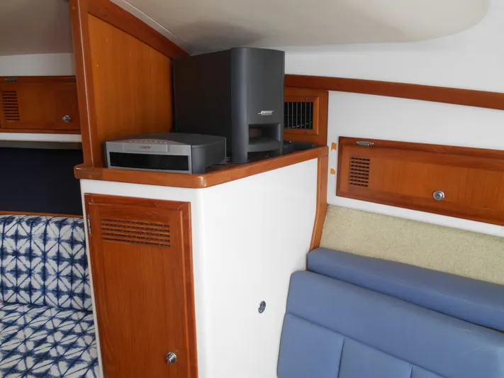 Mistress Yacht Photos Pics Interior of a 1998 Cabo 31 Express boat with wood paneling and seating.