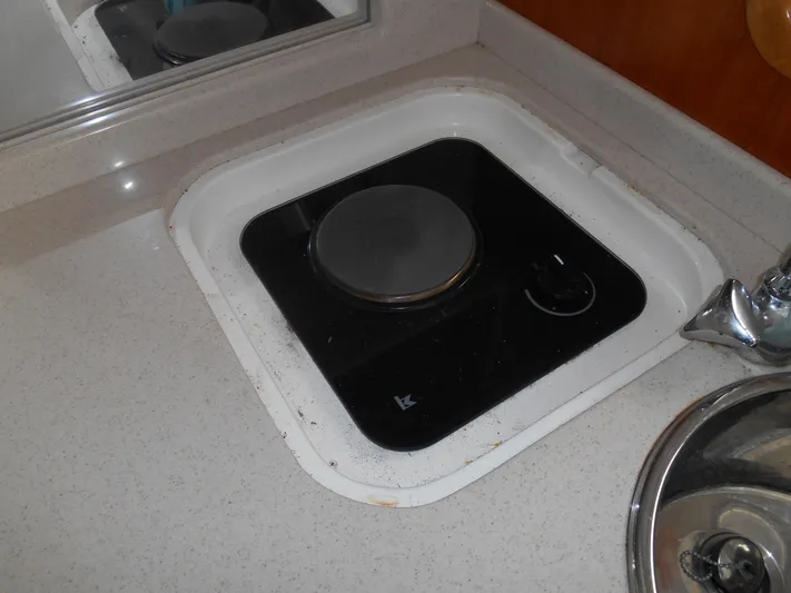 Mistress Yacht Photos Pics 1998 Cabo 31 Express boat kitchen with built-in electric stove and sink.