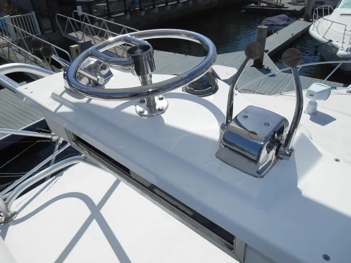 Mistress Yacht Photos Pics Helm of 1998 Cabo 31 Express boat with steering wheel and throttle controls.