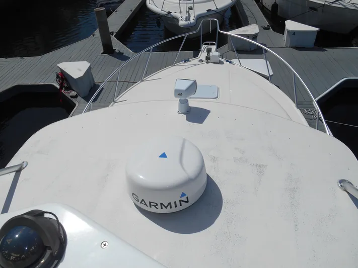 Mistress Yacht Photos Pics 1998 Cabo 31 Express boat with Garmin equipment docked at a marina.