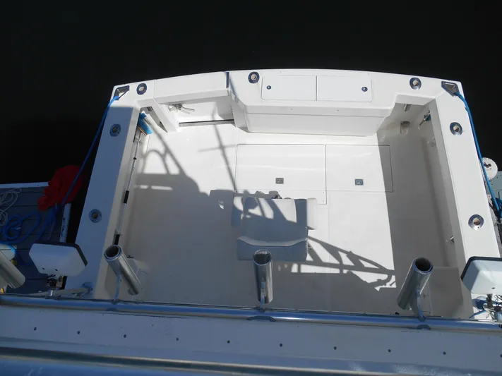 Mistress Yacht Photos Pics 1998 Cabo 31 Express boat deck, featuring spacious layout and rod holders.