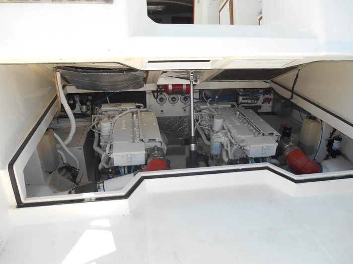 Mistress Yacht Photos Pics Engine compartment of a 1998 Cabo 31 Express boat, showcasing dual engines and mechanical components.