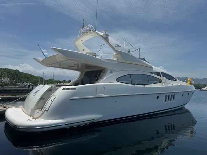 Stella Mia Yacht Photos Pics Luxury 2001 Azimut 68 Plus yacht docked in serene marina setting.