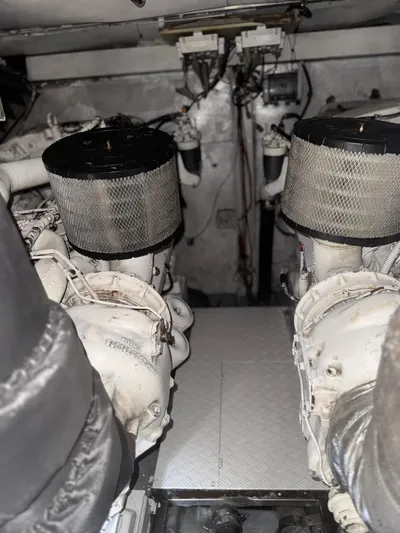 Stella Mia Yacht Photos Pics Engine room of a 2001 Azimut 68 Plus yacht, featuring dual engines and air filters.
