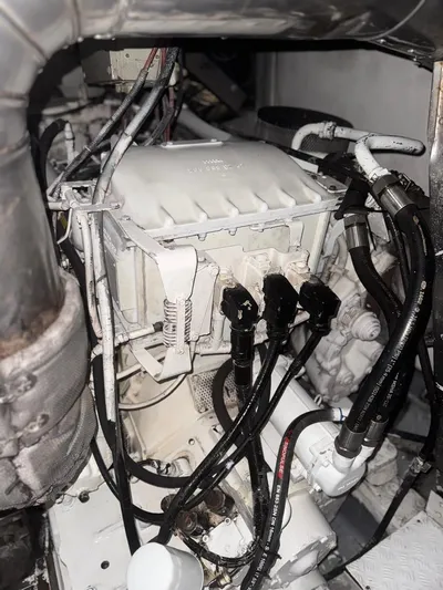 Stella Mia Yacht Photos Pics Engine compartment of a 2001 Azimut 68 Plus yacht, featuring complex wiring and components.