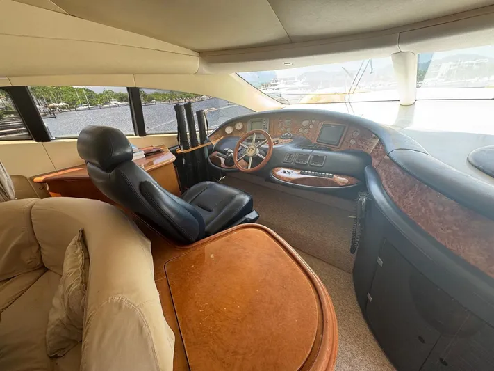 Stella Mia Yacht Photos Pics Luxurious helm of 2001 Azimut 68 Plus yacht with leather seating and wood accents.