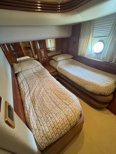 Stella Mia Yacht Photos Pics Luxurious twin cabin in 2001 Azimut 68 Plus yacht with elegant bedding.