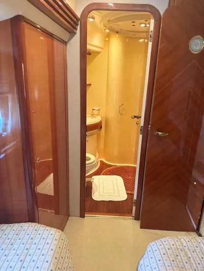 Stella Mia Yacht Photos Pics Luxurious bathroom interior of 2001 Azimut 68 Plus yacht with wooden finishes.