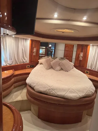 Stella Mia Yacht Photos Pics Luxurious bedroom interior of 2001 Azimut 68 Plus yacht with elegant wood finishes.